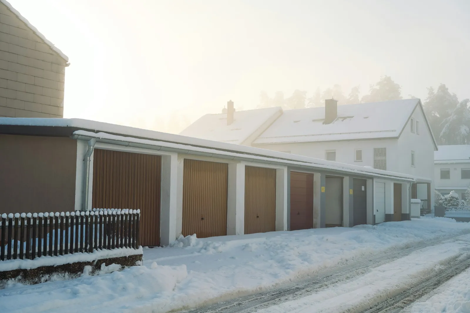 Row of residential garage doors covered in snow during a Spokane winter